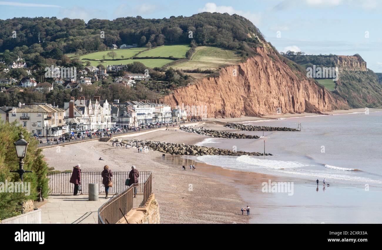 View across Sidmouth seafront and beach from Connaught Gardens. Sandstone cliffs showing erosion and cliff falls. Stock Photo