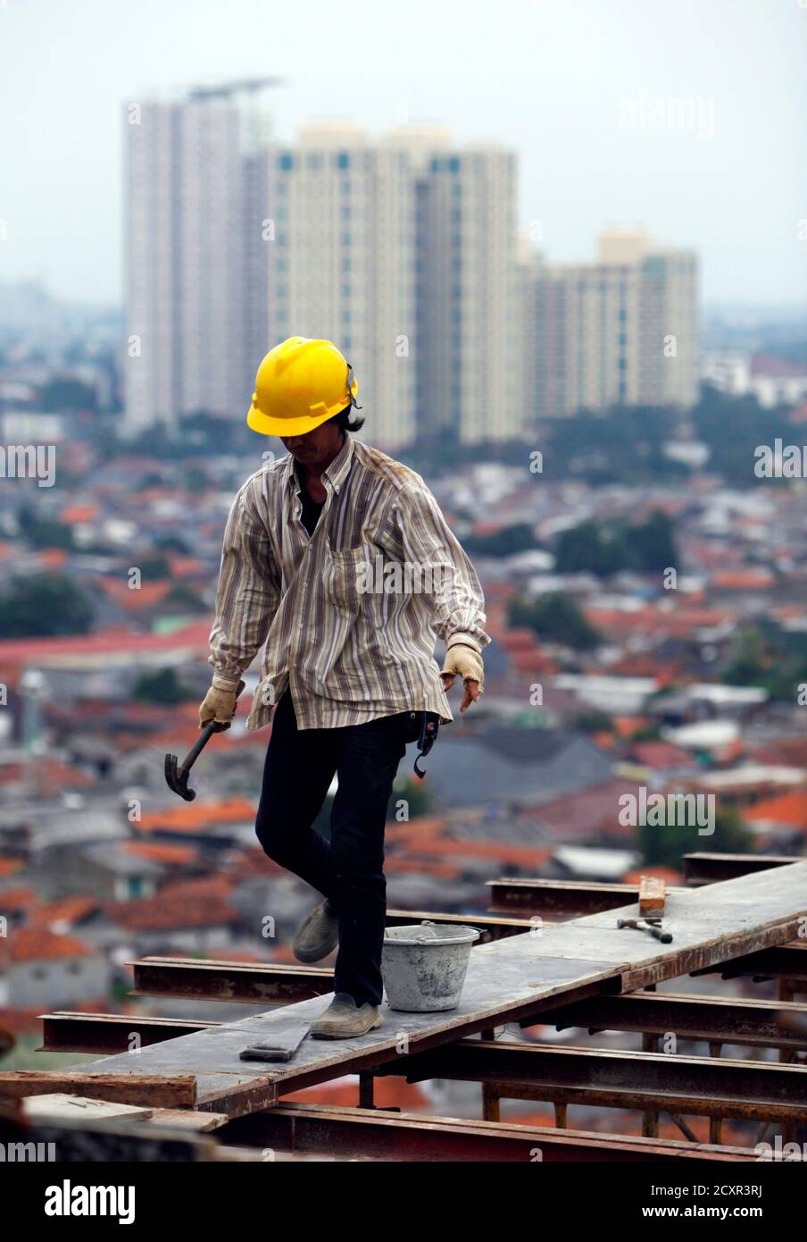 A Worker Walks On A Steel Bar On The 18th Floor Of The Wave At Rasuna Epicentrum Construction Site In Jakarta January 24 2011 The Indonesian Investment Board Bkpm Expects Total Investment<script async src=