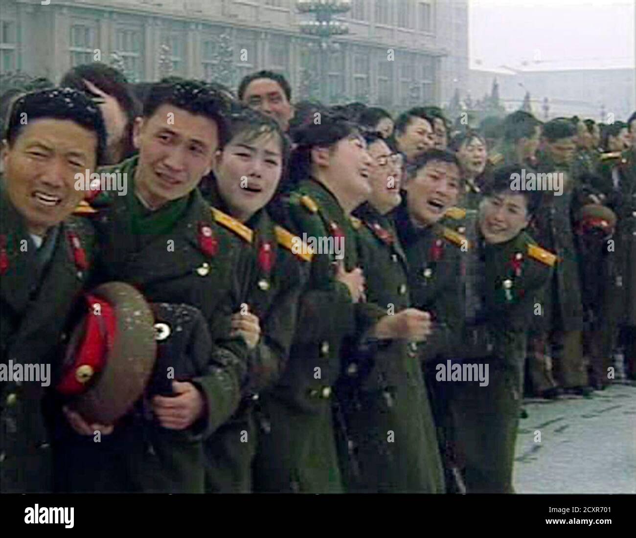 Military personnel react during Kim Jong-il's funeral procession in Pyongyang in this still image taken from video December 28, 2011. North Korea's military staged a huge funeral procession on Wednesday in the snowy streets of the capital Pyongyang for its deceased 'dear leader,' Kim Jong-il, readying a transition to his son, Kim Jong-un.    REUTERS/KRT via Reuters TV     (NORTH KOREA - Tags: POLITICS OBITUARY TPX IMAGES OF THE DAY) Stock Photo