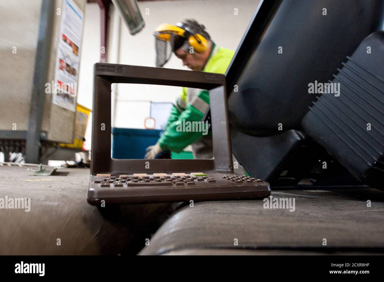 The plastic shell of a French Minitel terminal moves on a conveyor belt as it is broken down for recycling in Portet-Sur-Garonne, southwestern France May 23, 2012. The Minitel, the box-like terminal with a keyboard and monochrome screen, was introduced on the market in 1982 by telecommunications operator France Telecom and used by the French to get information as a phone directory or to purchase train tickets. Although there are between 600,000 - 700,000 of the units still in use, the Minitel service will end on June 30, 2012.    REUTERS/Bruno Martin   (FRANCE - Tags: SCIENCE TECHNOLOGY ENVIRO Stock Photo
