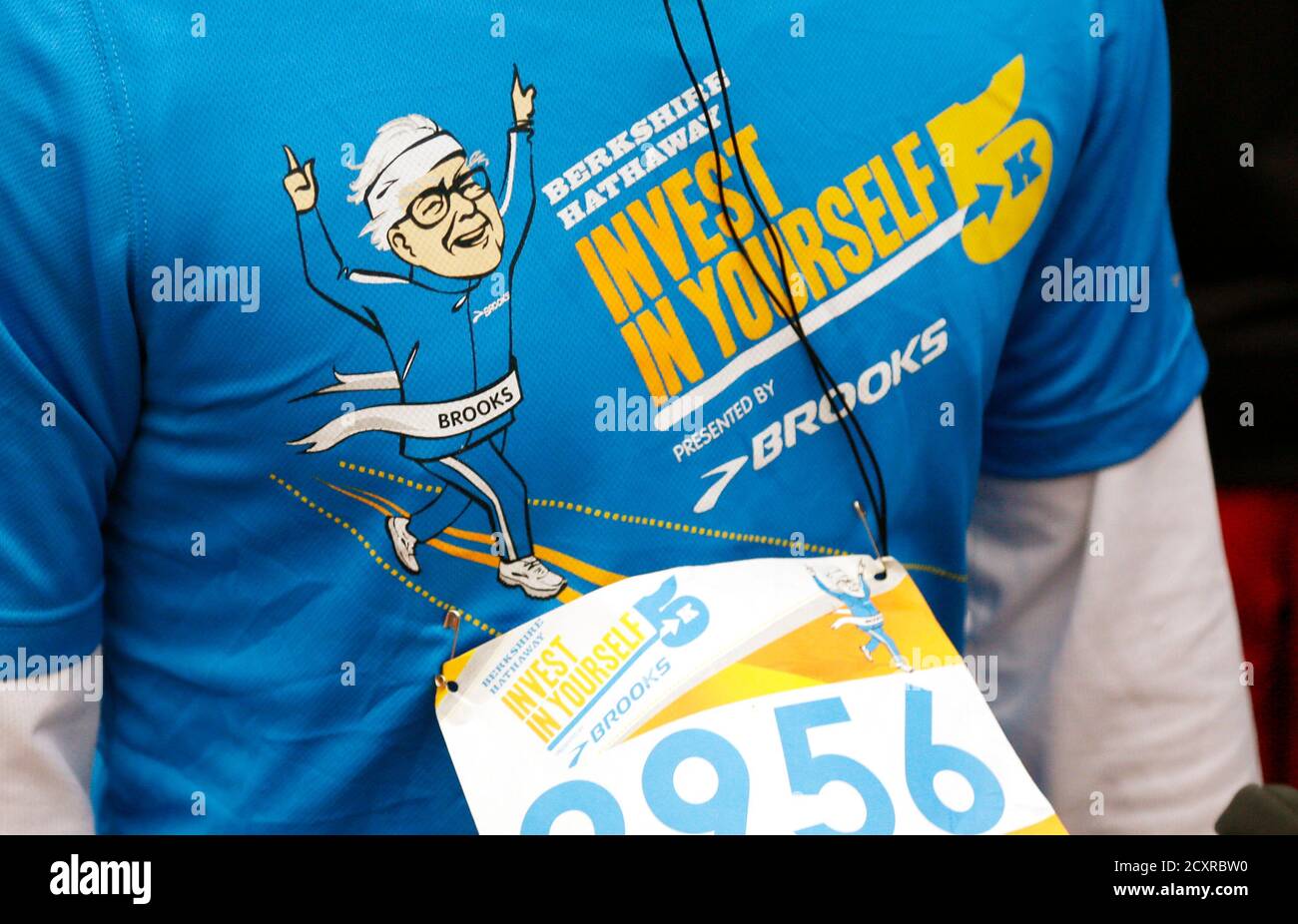 A cartoon of Berkshire Hathaway chairman Warren Buffett is seen on a  runner's shirt before a 5km race sponsored by Brooks Sports Inc., a  Berkshire-owned company, in Omaha May 5, 2013, the