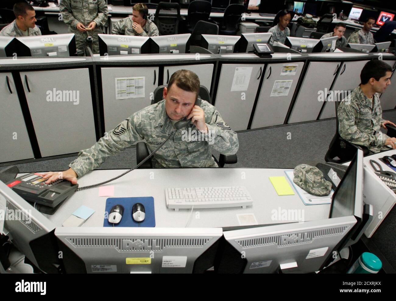 MSgt Michael Gregory, senior operations controller, works at the Air Force Space Command Network Operations & Security Center at Peterson Air Force Base in Colorado Springs, Colorado July 20, 2010. U.S. national security planners are proposing that the 21st century's critical infrastructure -- power grids, communications, water utilities, financial networks -- be similarly shielded from cyber marauders and other foes. The ramparts would be virtual, their perimeters policed by the Pentagon and backed by digital weapons capable of circling the globe in milliseconds to knock out targets.  To matc Stock Photo