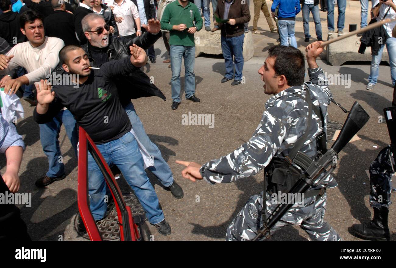 A supporter of the Kataeb party clashes with security forces during a demonstration organised by students affiliated with the Kataeb and the National Liberal Parties, in Beirut, March 10, 2012. The demonstration was against a new proposed version of a Lebanese history book. REUTERS/ Hussam Shebaro   (LEBANON - Tags: CIVIL UNREST EDUCATION) Stock Photo