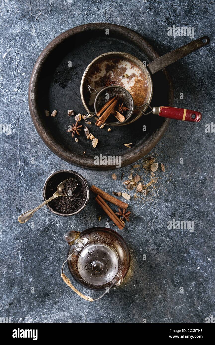 Vintage pot of traditional indian masala chai tea with ingredients ...