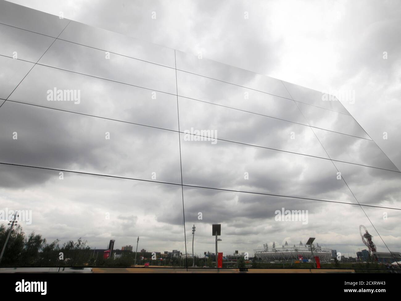 The Olympic Stadium is reflected in a corporate sponsor's pavilion in Olympic Park, Stratford, east London, July 19, 2012. The 2012 London Olympic Games will begin in just over a week.  REUTERS/Andrew Winning (BRITAIN - Tags: SPORT OLYMPICS) Stock Photo