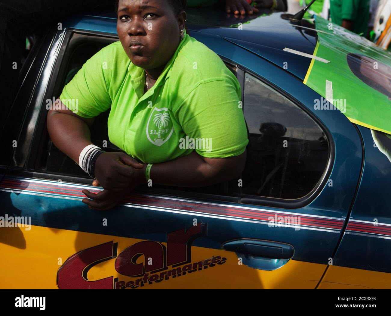 A supporter of Sierra Leone opposition presidential candidate Julius Maada  Bio peers out the window of a taxi at Bio's final campaign rally in  Freetown November 15 2012. Incumbent President Ernest Bai