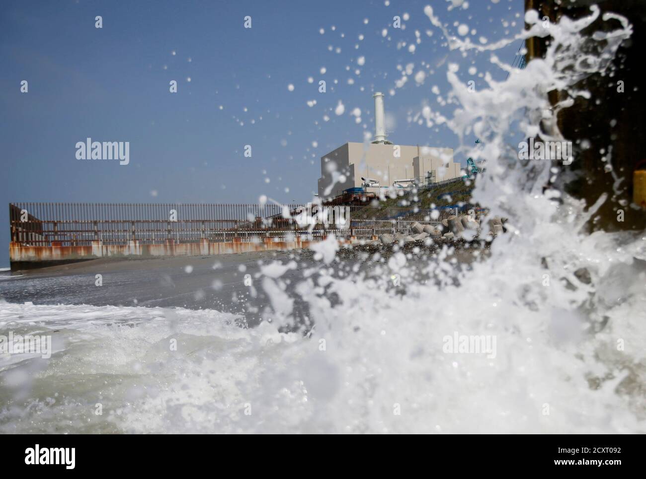 Chubu Electric Power Co S Hamaoka Nuclear Power Station Is Seen In The Distance As Waves Crash On A Beach In Omaezaki Shizuoka Prefecture May 17 13 Chubu Electric Is Spending At Least