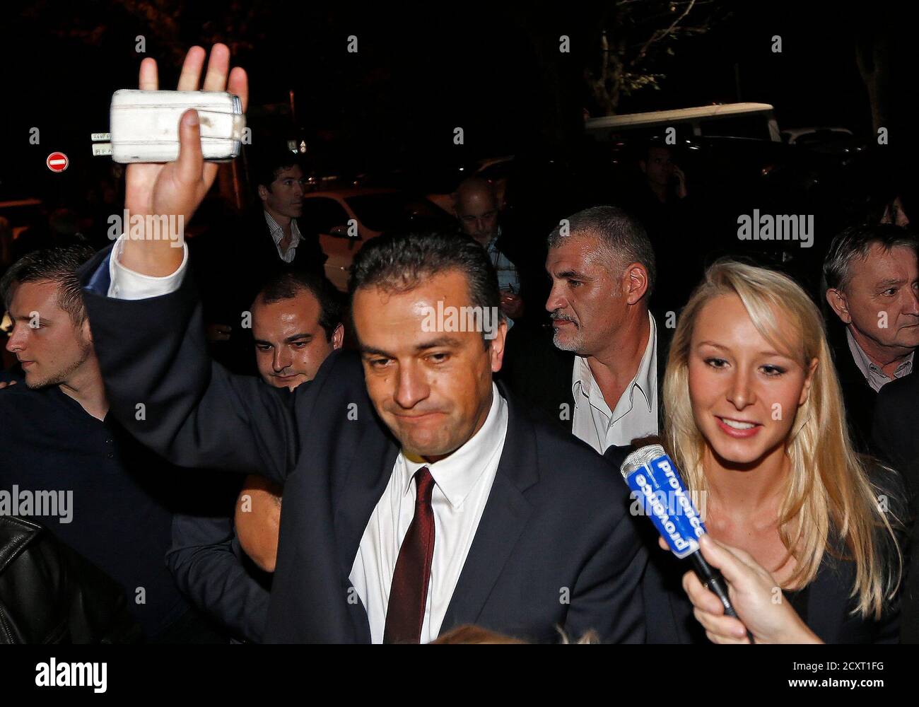 Front National Front party candidate, Laurent Lopez (L), waves to  supporters as he arrives with French National Front party deputy Marion  Marechal-Le Pen (R) after winning the second round of the local