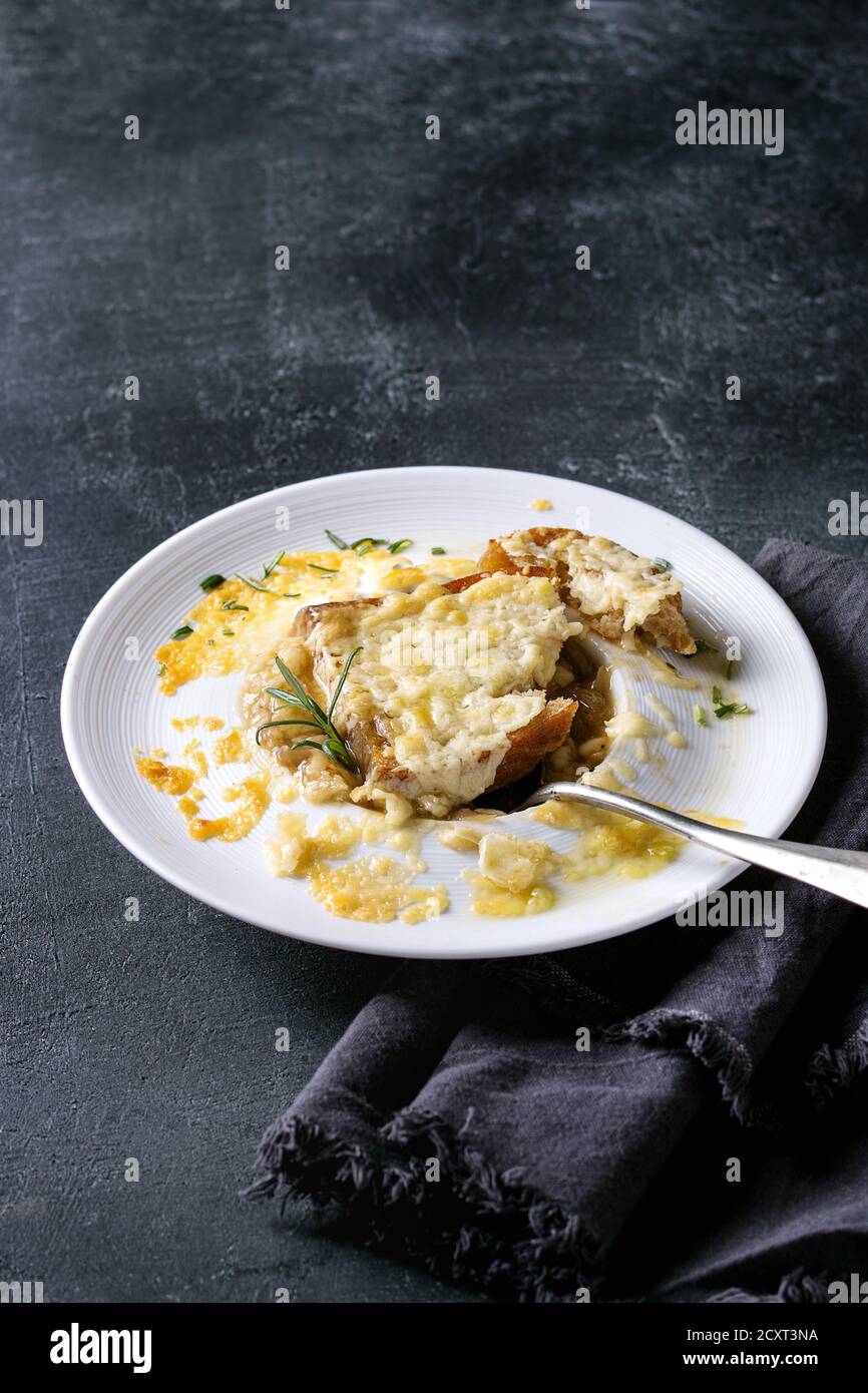 Traditional french onion soup with cheese and bread served in white