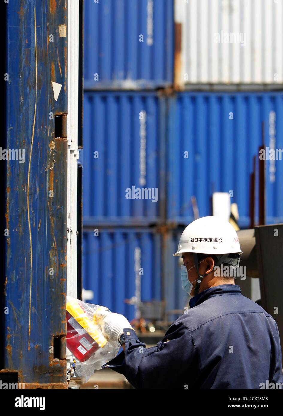 A certified radiation protection supervisor conducts a radiation screening  on the global shipping line APL's container at a terminal gate of Yokohama  port in Yokohama, south of Tokyo, April 26, 2011. APL
