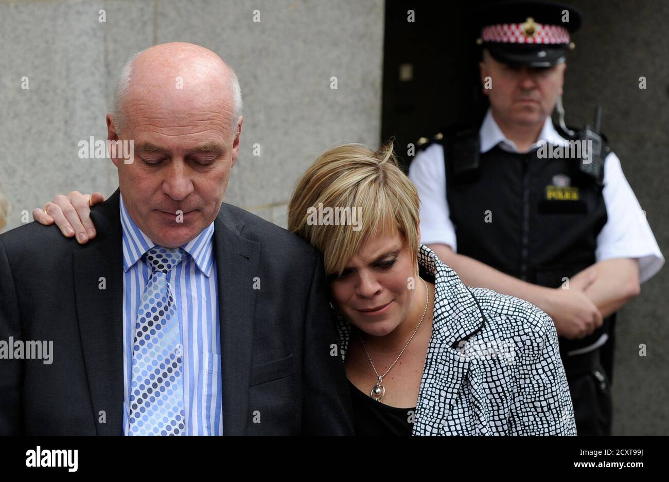 Bob Dowler, father of slain schoolgirl Milly Dowler, reads a statement next to his daughter Gemma (C) outside The Old Bailey courthouse in London June 24, 2011. A jury which found convicted killer Levi Bellfield guilty of murdering Milly Dowler in 2002 and was deliberating over whether he also tried to kidnap another young girl has been discharged because of adverse media publicity. The former nightclub doorman was convicted at the Old Bailey of killing the 13-year-old after she walked past his home in Walton on Thames, Surrey.  REUTERS/Paul Hackett  (BRITAIN - Tags: CRIME LAW) Stock Photo
