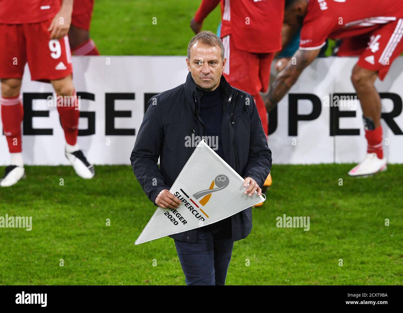 Allianz Arena Munich Germany 30.09.20, Football: German SUPERCUP FINALE 2020/2021, FC Bayern Muenchen (FCB, red) vs Borussia Dortmund  (BVB, yellow) 3:2 — manager  Hansi Flick (FCB) with Supercup pennant   Foto: Markus Ulmer/Pressefoto Ulmer/Pool/via Kolvenbach  DFL regulations prohibit any use of photographs as image sequences and/or quasi-video. Stock Photo