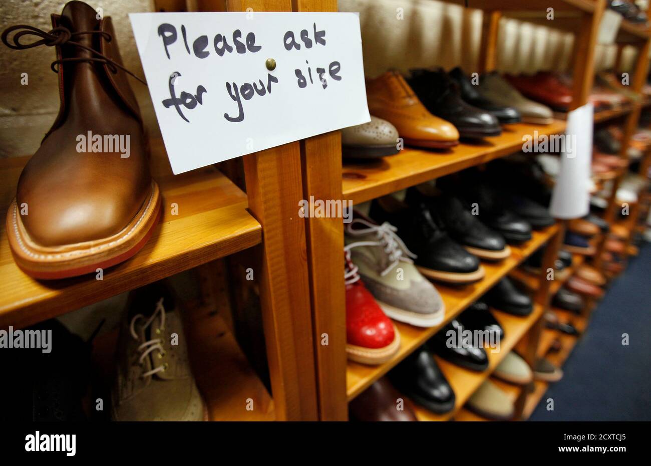 Shoes are displayed at the Tricker's shoe factory in Northampton, central  England, April 25, 2012. The small wooden door of Tricker's shoe factory  unexpectedly leads to a smartly polished showroom, its dark