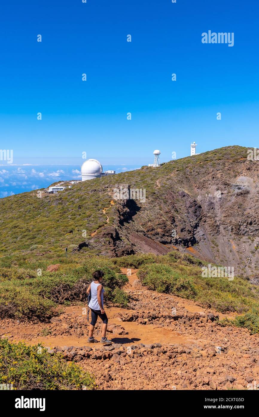 Nordic Optical Telescope and young female at mountain top on the island