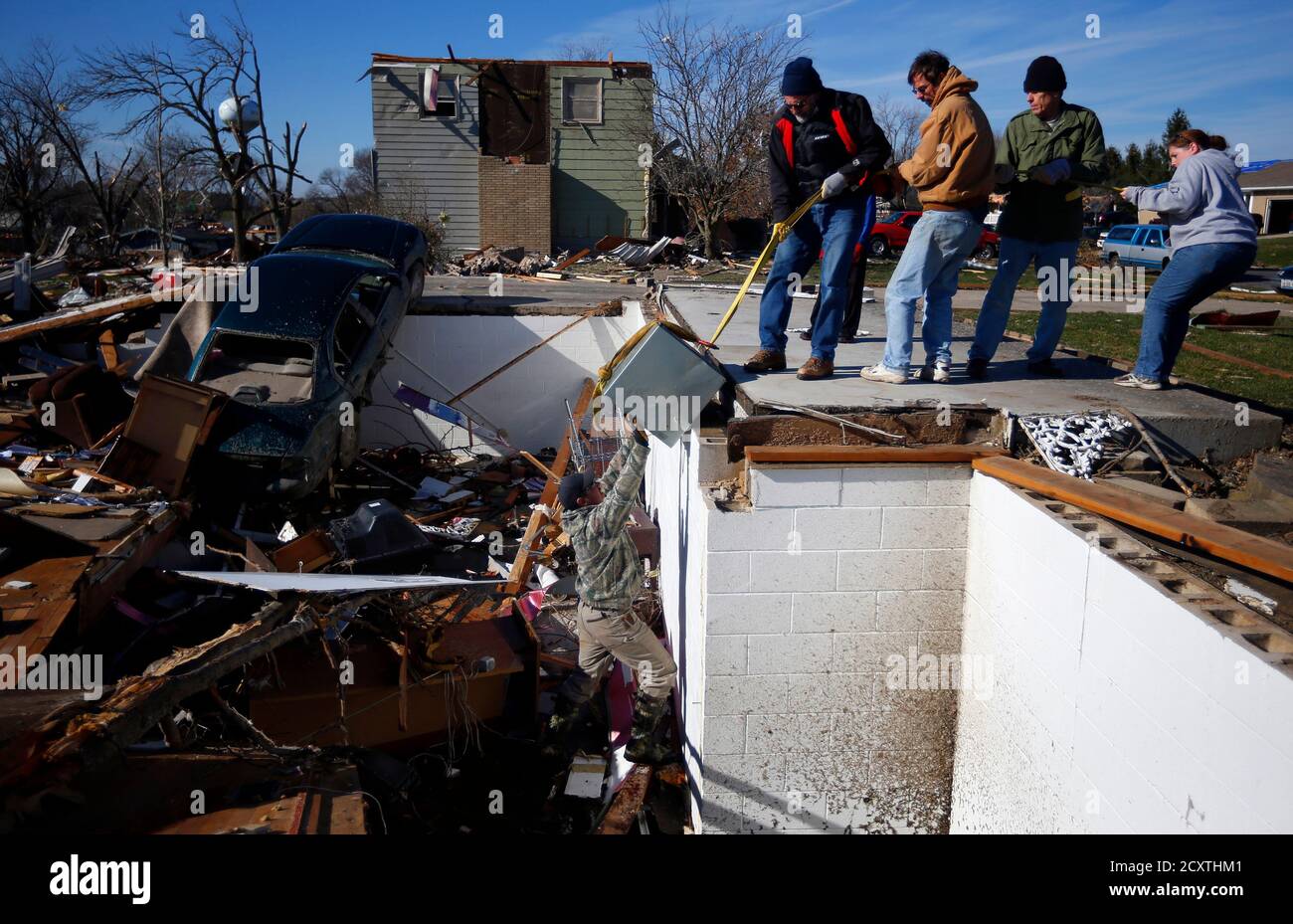 blake-martin-l-pushes-a-safe-out-of-his-neighbors-basement-as-other-neighbors-pull-from-above-in-washington-illinois-november-19-2013-rescue-workers-in-a-small-illinois-city-raked-by-a-powerful-tornado-were-combing-through-the-wreckage-on-tuesday-in-the-wake-of-a-fast-moving-storm-that-killed-eight-people-in-two-states-and-may-have-caused-1-billion-62104086449-in-property-damage-reutersjeff-haynes-united-states-tags-disaster-environment-2CXTHM1.jpg