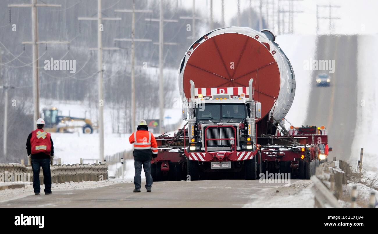 Trucks transporting a Cracking reactor take up an entire two lane highway  east of Redwater, Alberta on their way to the site of a new refinery south  of Redwater which is about