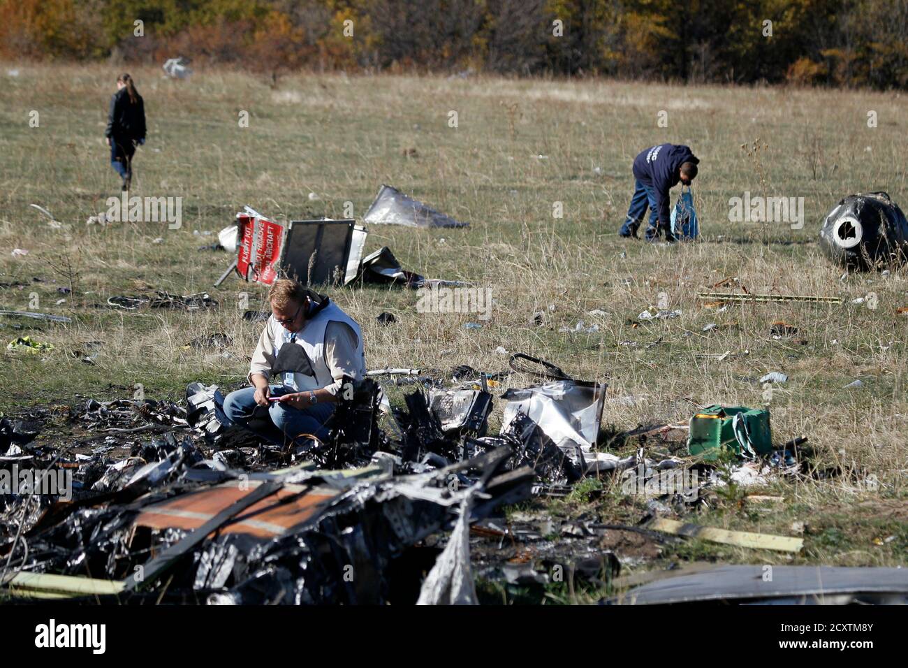 Members of the recovery team work at the site where the ...