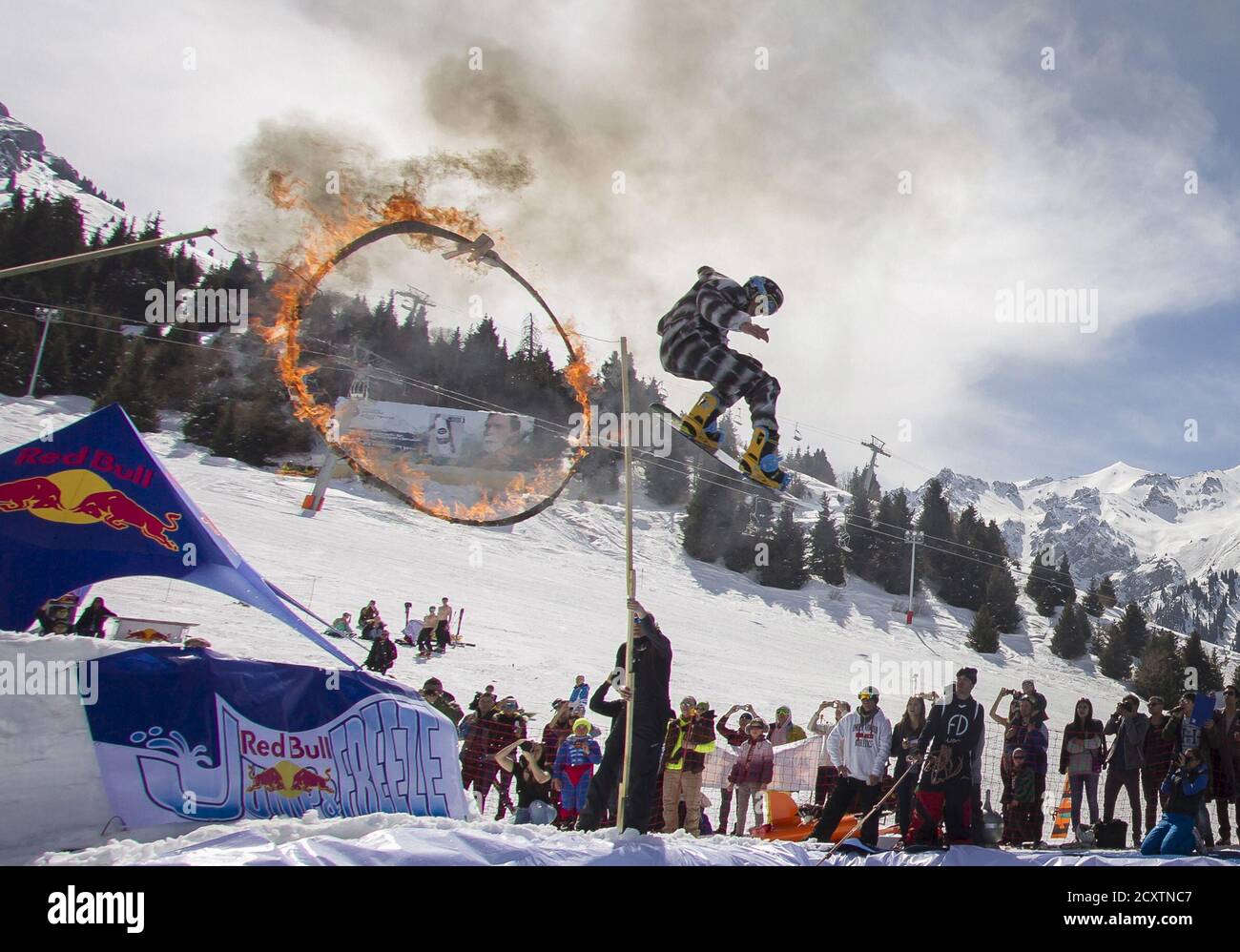 træner segment teater A snowboarder performs during the Red Bull Jump and Freeze competition at  ski resort Shimbulak outside Almaty March 22, 2015. Participants wearing  festive costumes perform tricks before getting into a pond with