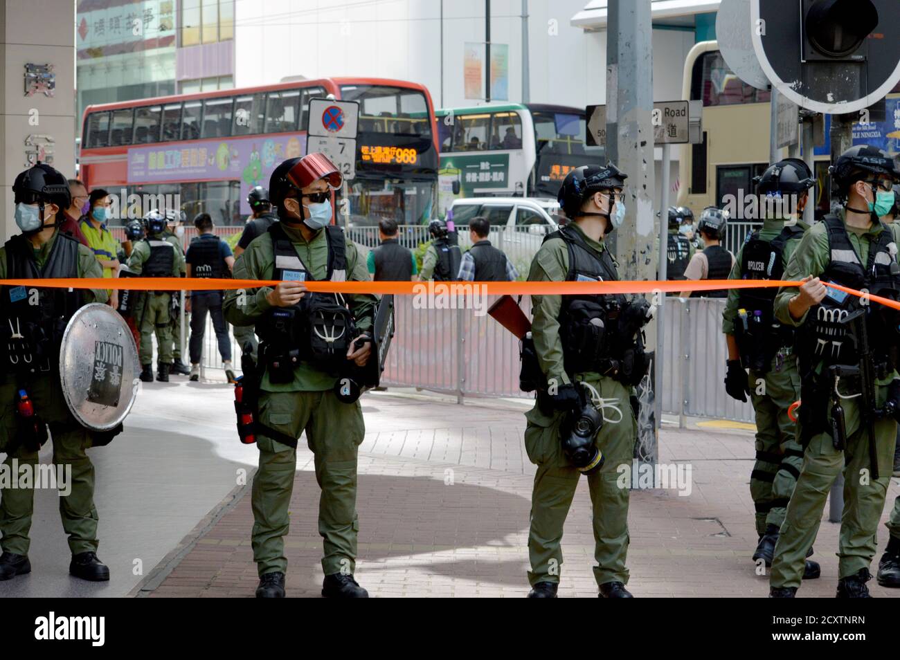 Hong Kong Police Force officers block a footpath in the Causeway Bay shopping district on National Day, 1 October 2020 Stock Photo