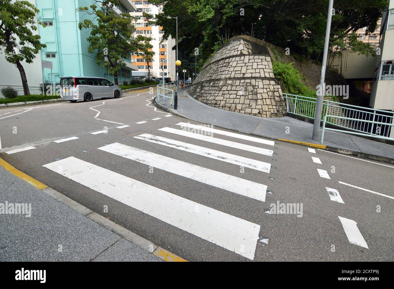 Hong Kong zebra crossing with yellow flashing Belisha beacons Stock