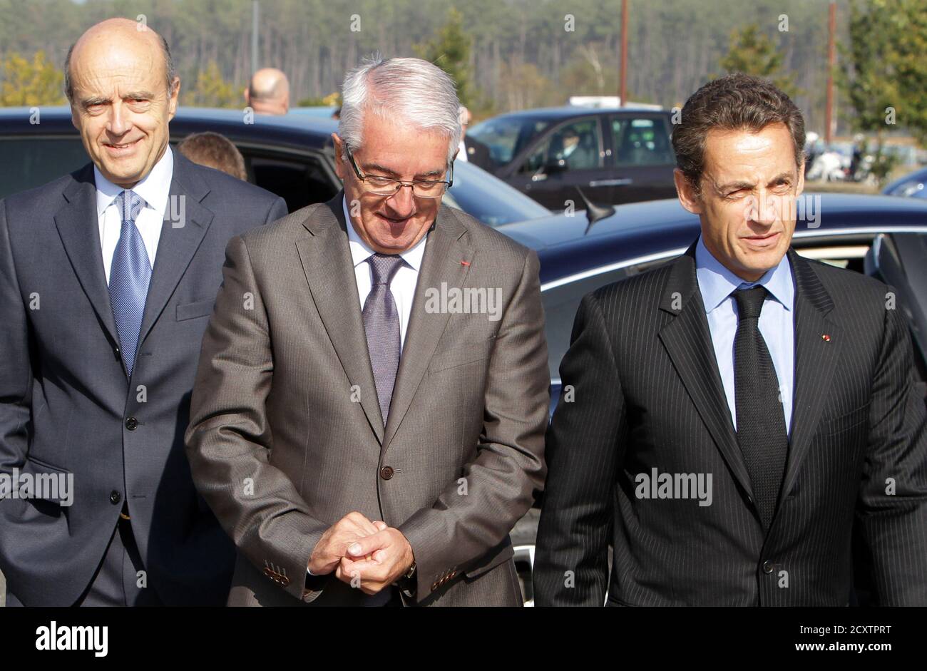 France's President Nicolas Sarkozy (R), Alain Juppe (L), former French  Prime Minister and Mayor of Bordeaux, and Alain Boudou (C), French  President of Bordeaux University, arrive to visit the Megajoule Laser  project,