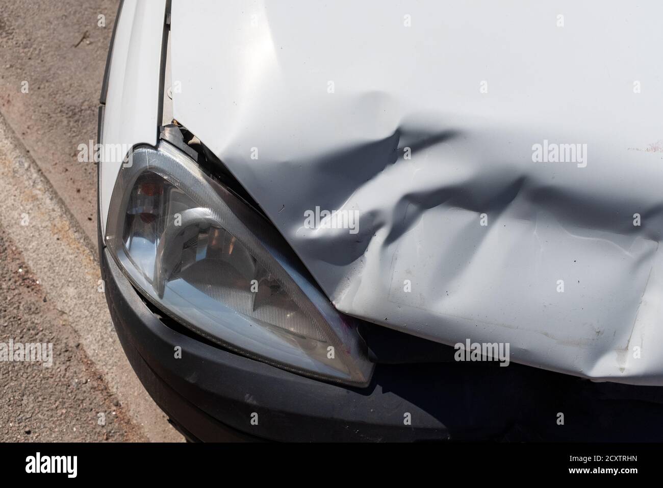 car after an accident. damage to the hood with headlight Stock Photo