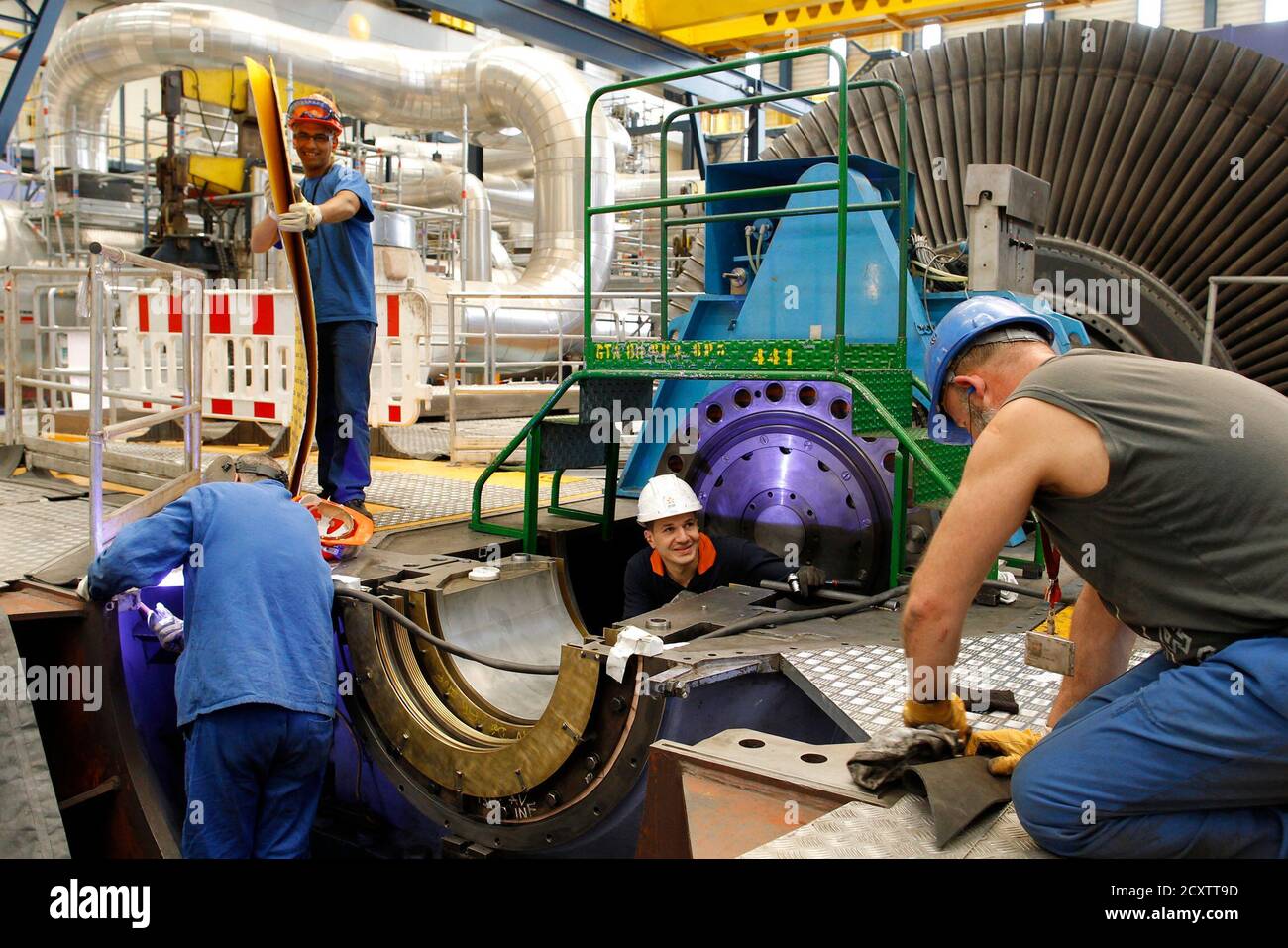 Technicians work near a turbine during a planned maintenance intervention at Bugey nuclear power plant in Saint-Vulbas, near Lyon April 19, 2011. Electricite de France (EDF) runs the country's nuclear
