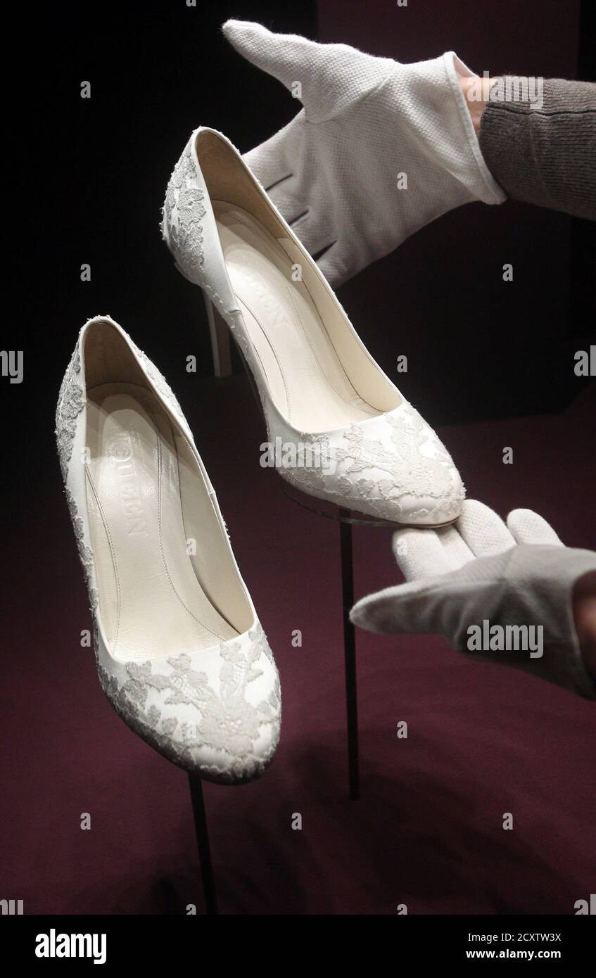 The bridal shoes of Britain's Catherine, Duchess of Cambridge are seen as  they are prepared for display at Buckingham Palace in London July 20, 2011.  Buckingham Palace expects record crowds this summer