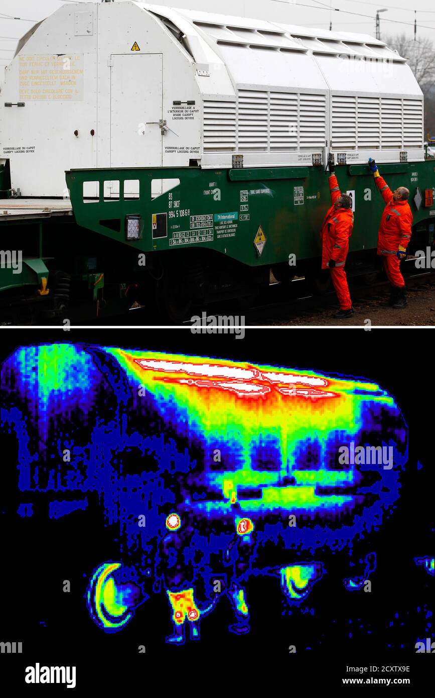 A combination of photos, one take with a thermal image camera (lower) shows  two German police officers using a Geiger counter to measure the radiation  of a Castor container on transport train,