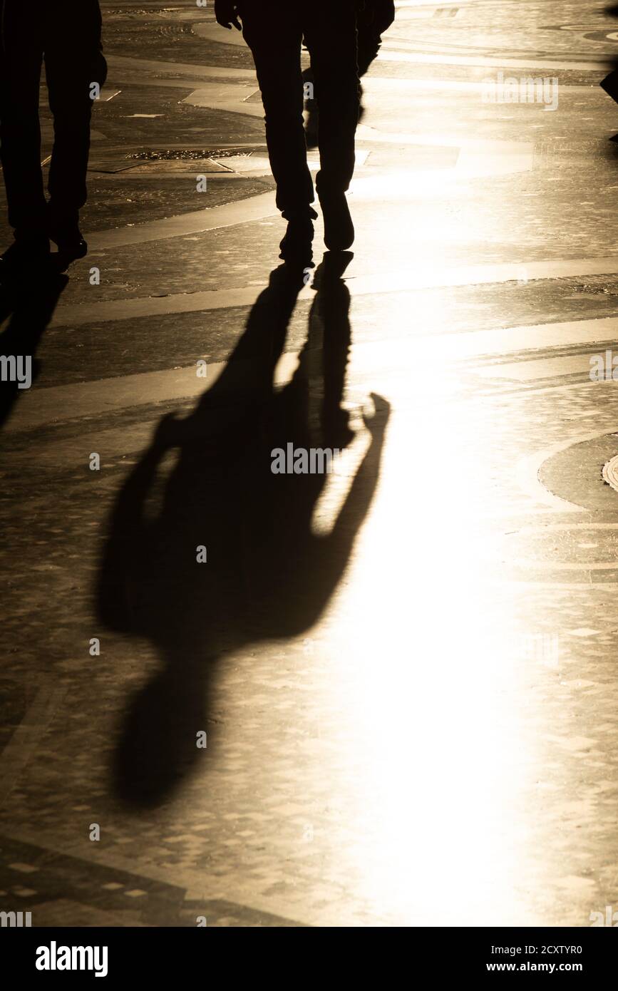 Italy, Lombardy, Milan, Galleria Vittorio Emanuele II, People Passing With Their Shadow on Mosaic Floor Stock Photo