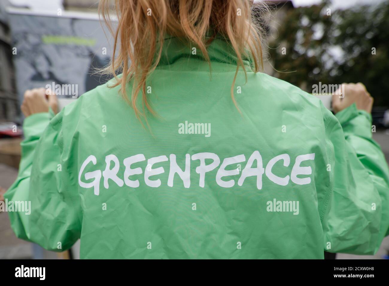 Bucharest, Romania - October 1, 2020: Greenpeace activist holding a banner at a protest. Stock Photo