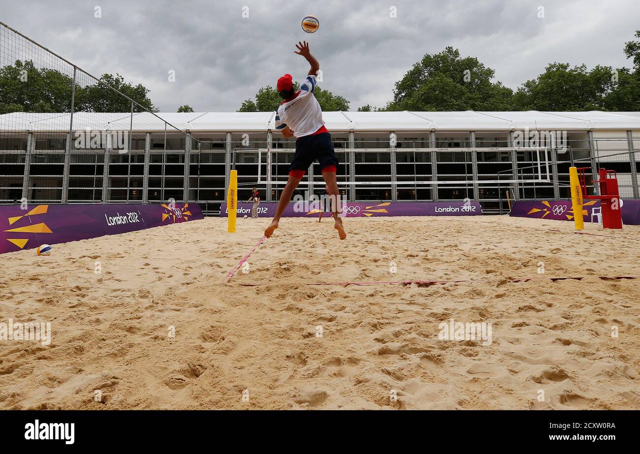 Britain's men's beach volleyball player John Garcia-Thompson practices his serve during a training session at the London 2012 Olympics beach volleyball venue in central London July 19, 2012. REUTERS/Suzanne Plunkett (BRITAIN - Tags: SPORT OLYMPICS SOCIETY VOLLEYBALL) Stock Photo