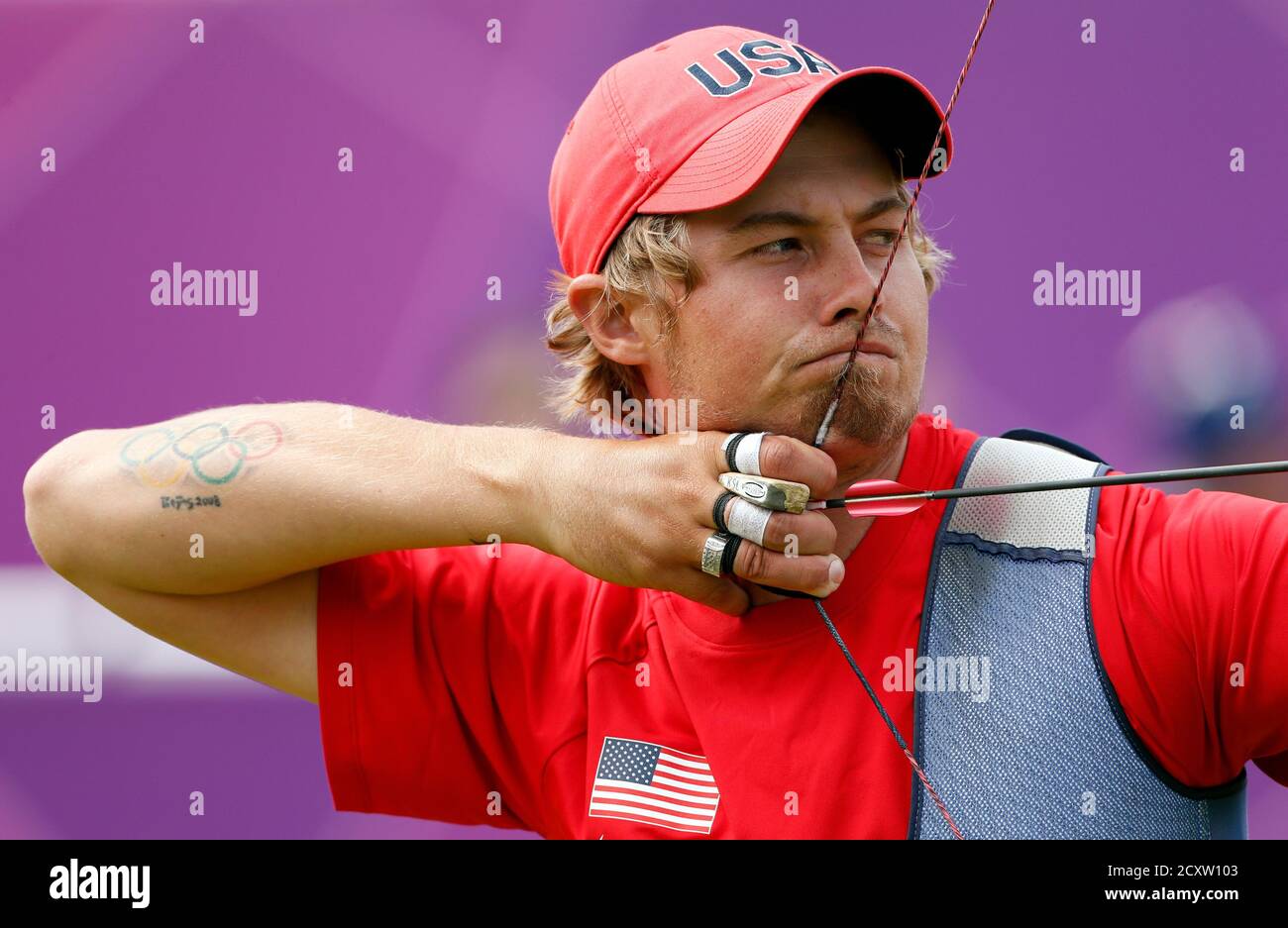 Elison Brady Of The U S With A Tattoo Of The Olympic Rings And The Words Beijing 08 On His Right Arm Takes Aim During The Men S Archery Individual Round Of 32 Eliminations