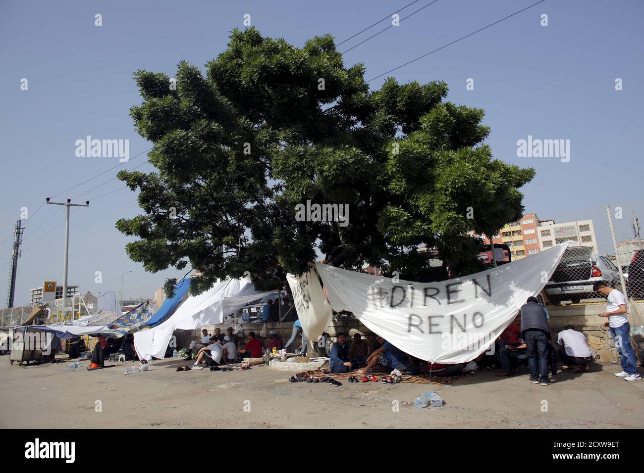 Protesting Workers Sit Under A Tree In Front Of Renault Car Plant In Bursa Turkey May