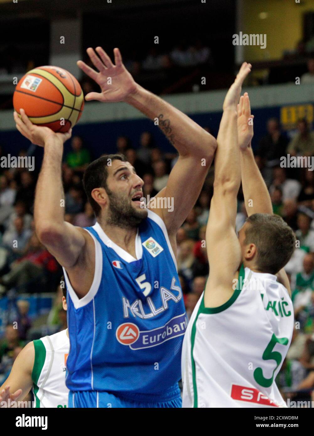 Ioannis Bourousis of Greece (L) goes for a basket past Jaka Lakovic of  Slovenia during their FIBA EuroBasket 2011 Group F basketball game in  Vilnius September 8, 2011. REUTERS/Ints Kalnins (LITHUANIA -