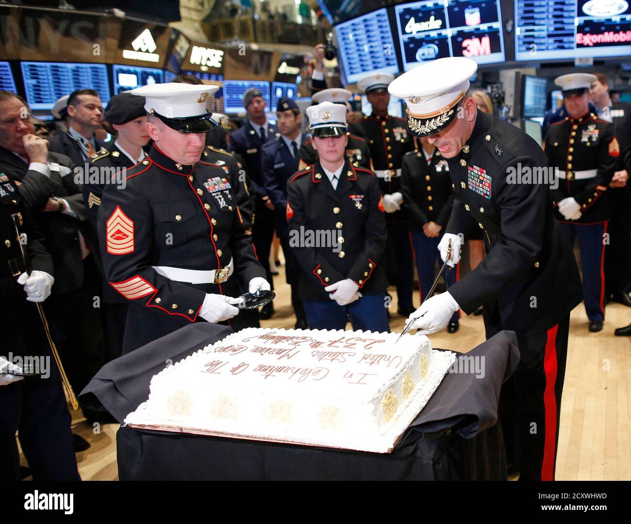 U.S. Marine Corps Major General Michael Dana (R) uses a saber to slice a cake for the USMC's 237th birthday, on the floor of the New York Stock Exchange November 12, 2012.   REUTERS/Chip East (UNITED STATES - Tags: BUSINESS MILITARY ANNIVERSARY) Stock Photo