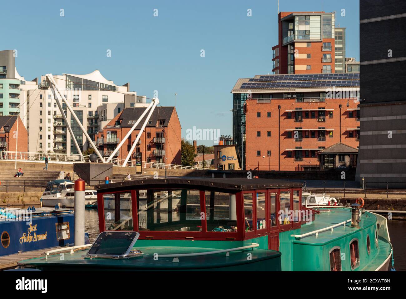 View of unidentified people and canal boats moored in Leeds Dock Stock Photo
