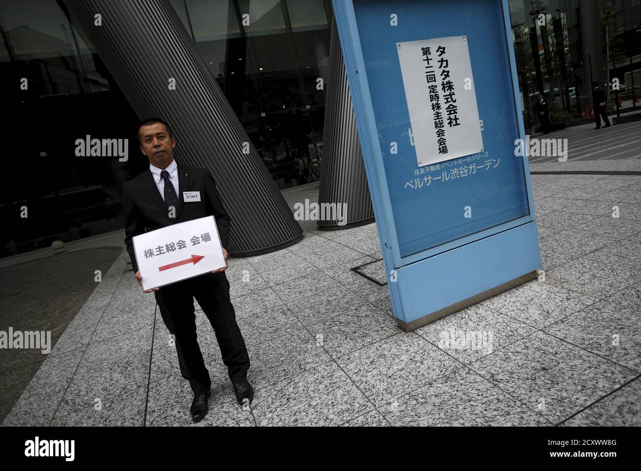 An Employee Of Japanese Auto Parts Maker Takata Corp Holds A Signboard Of The Company S Annual General Meeting Outside An Entrance Gate Of The Venue In Tokyo Japan June 25 15 Japan S