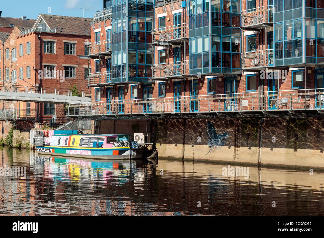 View of colourful barge on the River Aire in Leeds City Centre Stock Photo