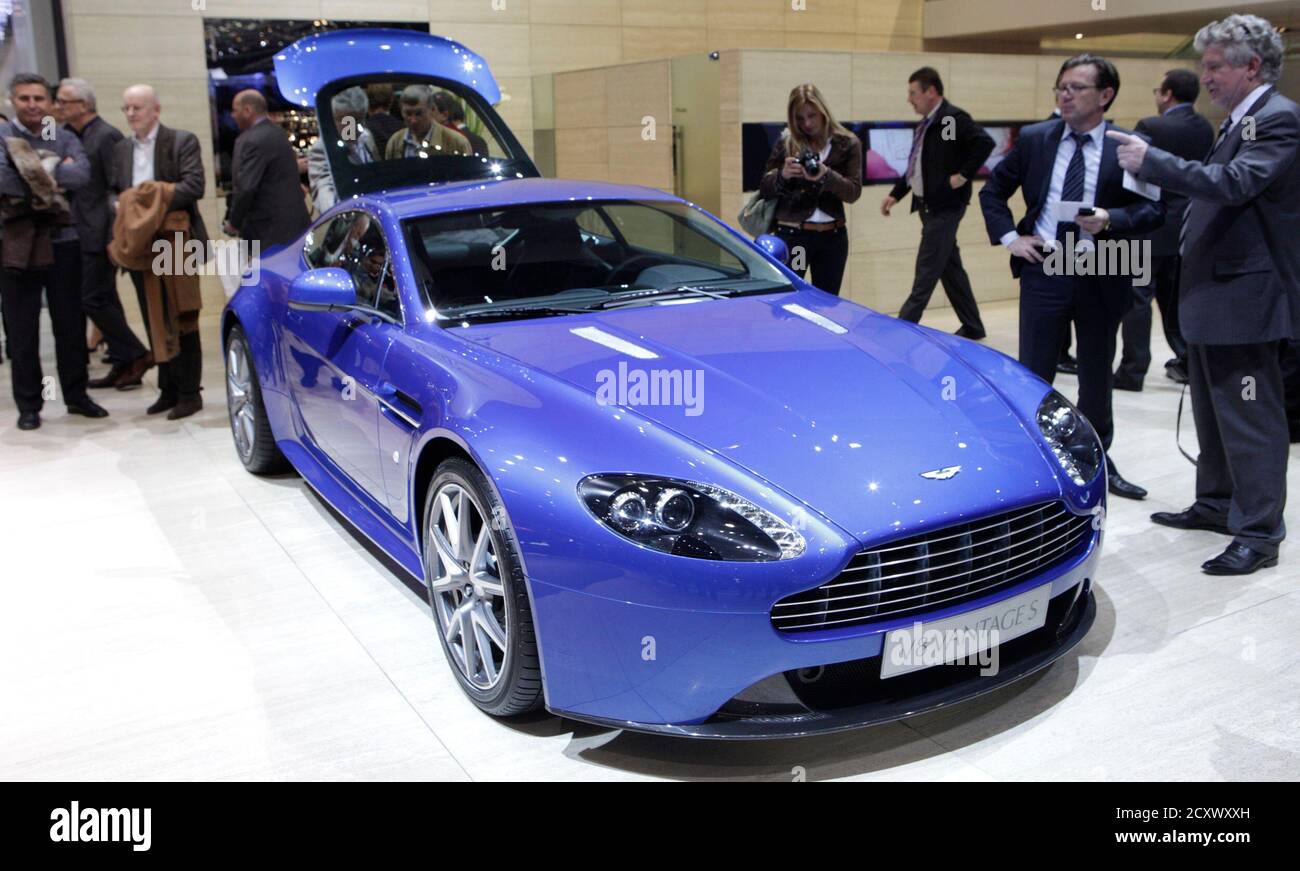 Visitors look at a new Aston Martin V8 Vantage S car displayed during the  first media day of the 81st Geneva International Motor Show at the Palexpo  in Geneva March 1, 2011.