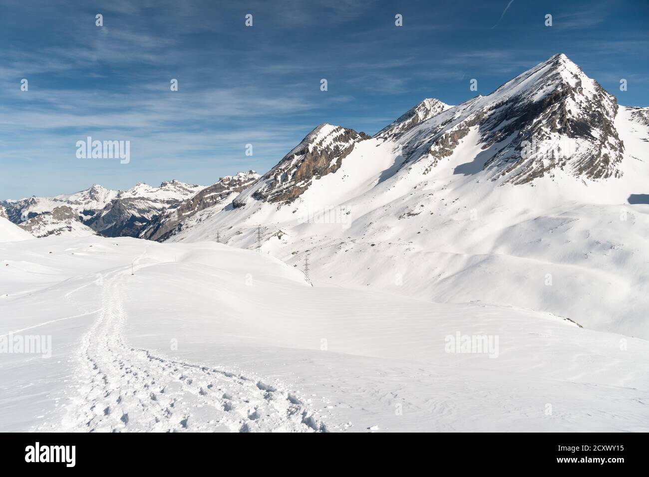 Snowshoes tracks on the gemmi pass near Leukerbad in Valais on a sunny winter day in Switzerland Stock Photo