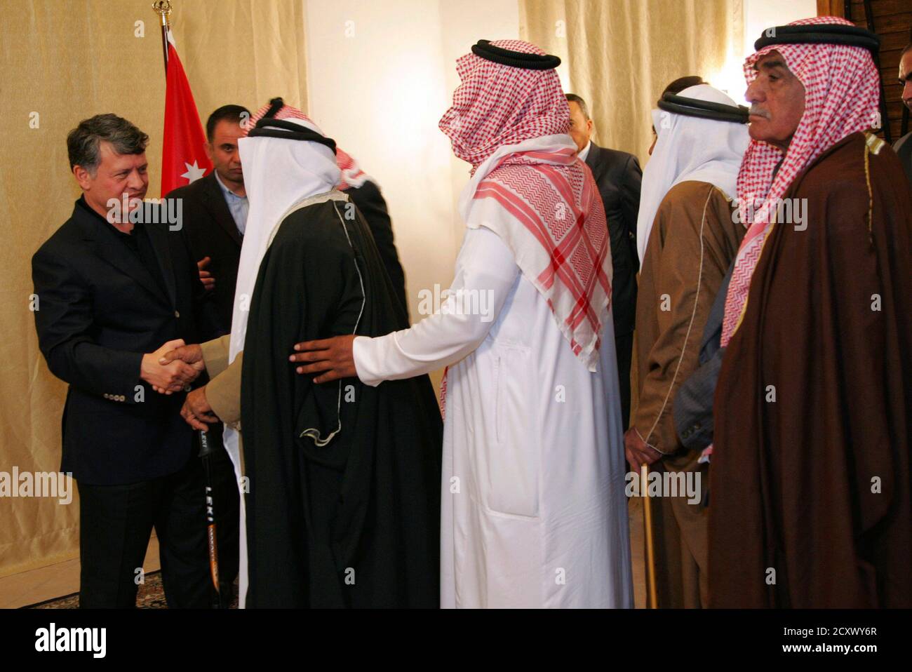 Jordan's King Abdullah (L) is greeted by leaders of Bedouin tribes during  his visit to the southern region of Petra, March 27, 2011. King Abdullah  stressed the importance of preserving national unity