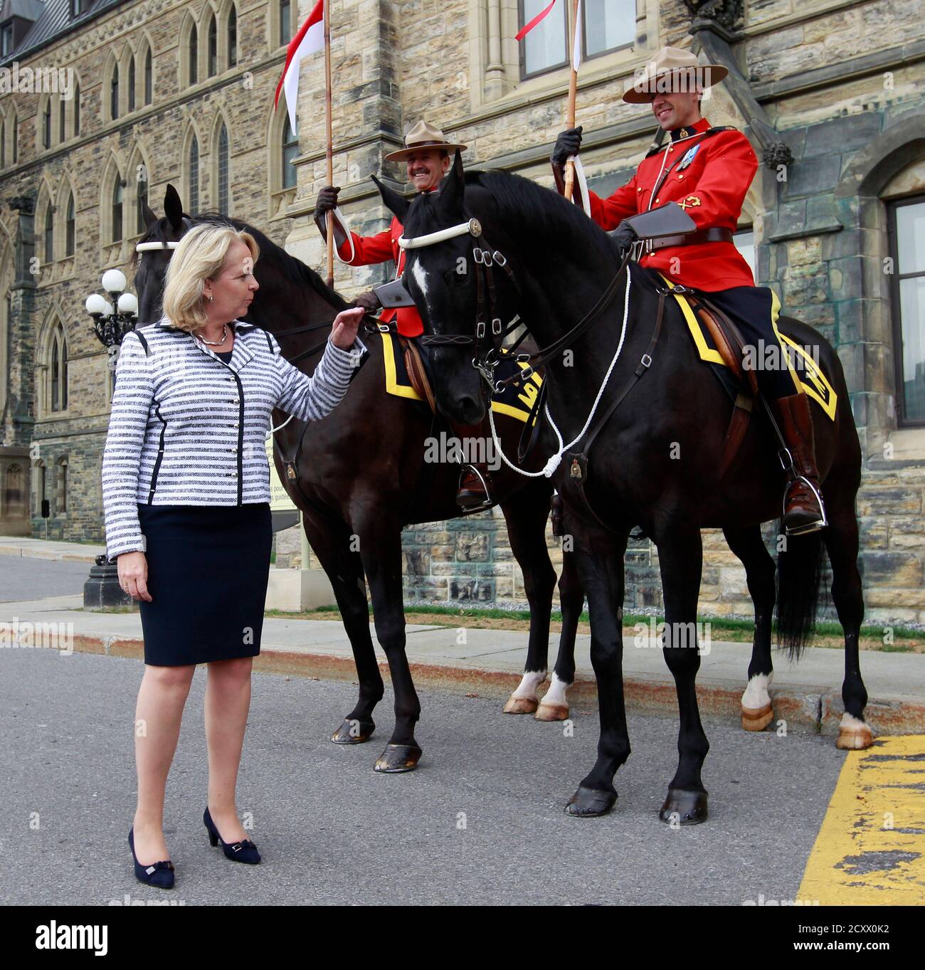 Hannelore Kraft, President of the Federal Council of Germany and North Rhine-Westphalia's state premier, pets a Royal Canadian Mounted Police horse during a visit on Parliament Hill in Ottawa September 8, 2011.       REUTERS/Chris Wattie       (CANADA - Tags: POLITICS) Stock Photo