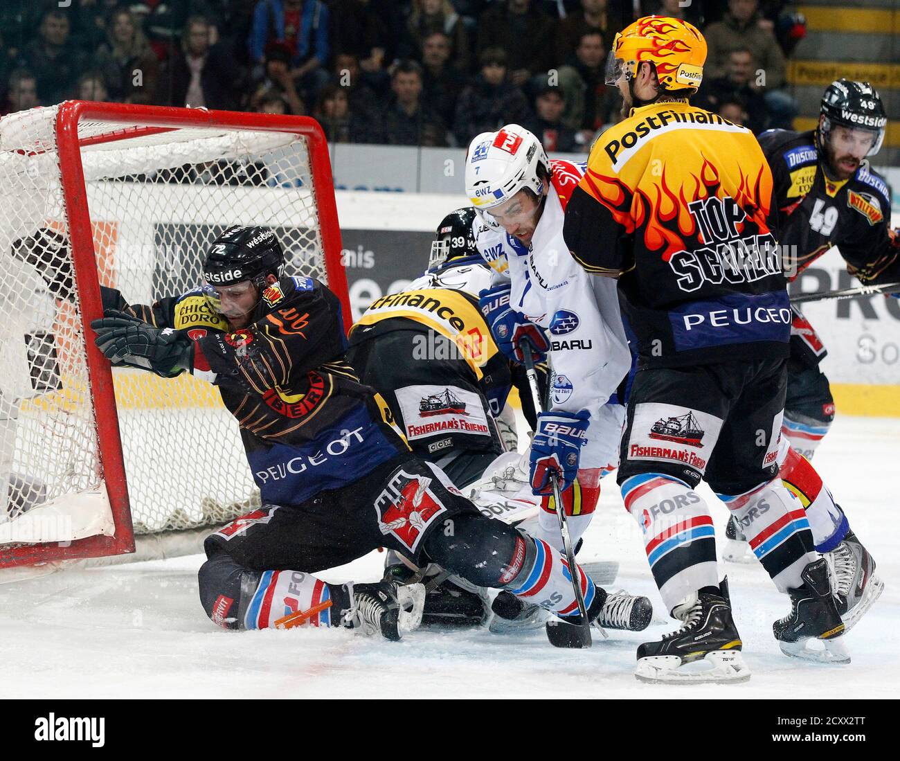 SC Bern's (SCB) David Jobin (L) and Byron Ritchie (R) fight for the puck  with ZSC Lion's Thibaut Monnet during their Swiss ice hockey play-off final  at the Post Finance Arena in