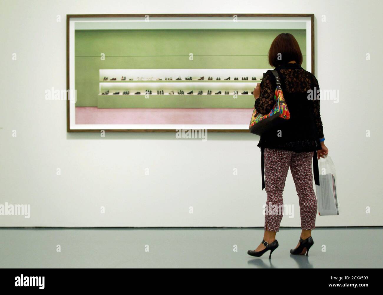 A woman looks at an artwork 'Prada I' by Andreas Gursky during a media  preview of his exhibition at the Museum Kunstpalast in Duesseldorf  September 20, 2012. The 'Andreas Gursky' exhibition, which