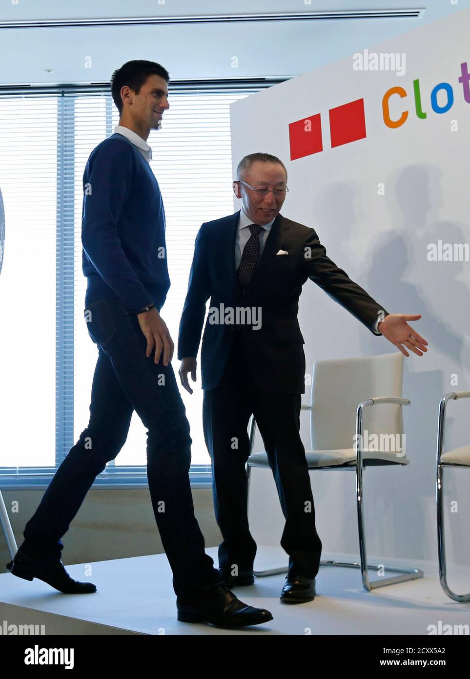 Tennis player and UNIQLO Brand Ambassador Novak Djokovic of Serbia (L) is  introduced by Tadashi Yanai, chairman and chief executive of Fast Retailing  Co, operator of Uniqlo budget fashion chain, during a