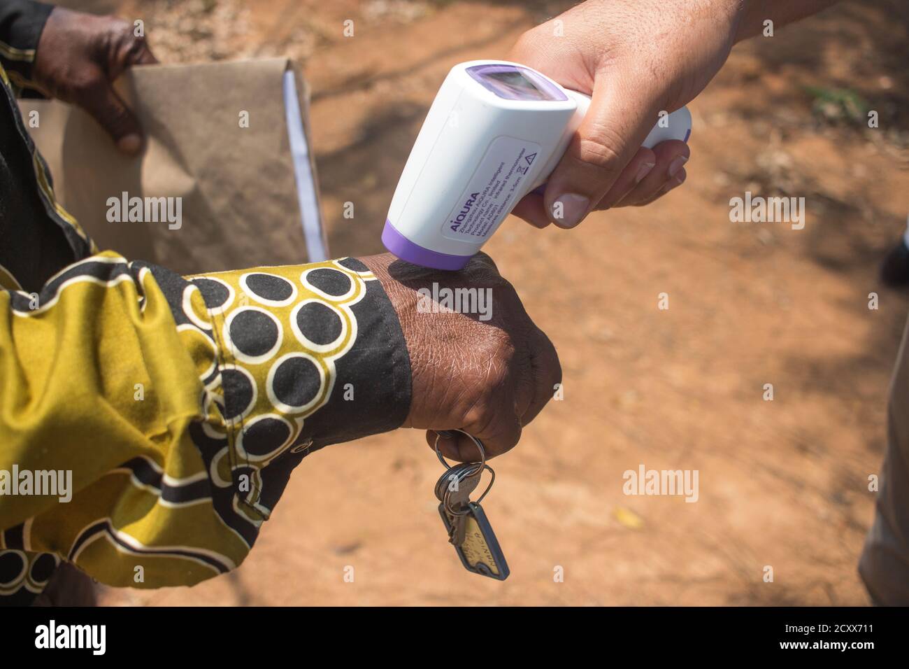 Thermometer being used to detect signs of coronavirus by measuring the ...
