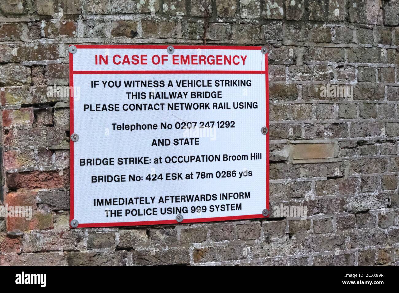 Woodbridge, Suffolk, UK - 1 October 2020: In case of emergency. Who to contact should the Broom Hill railway bridge be damaged. Stock Photo