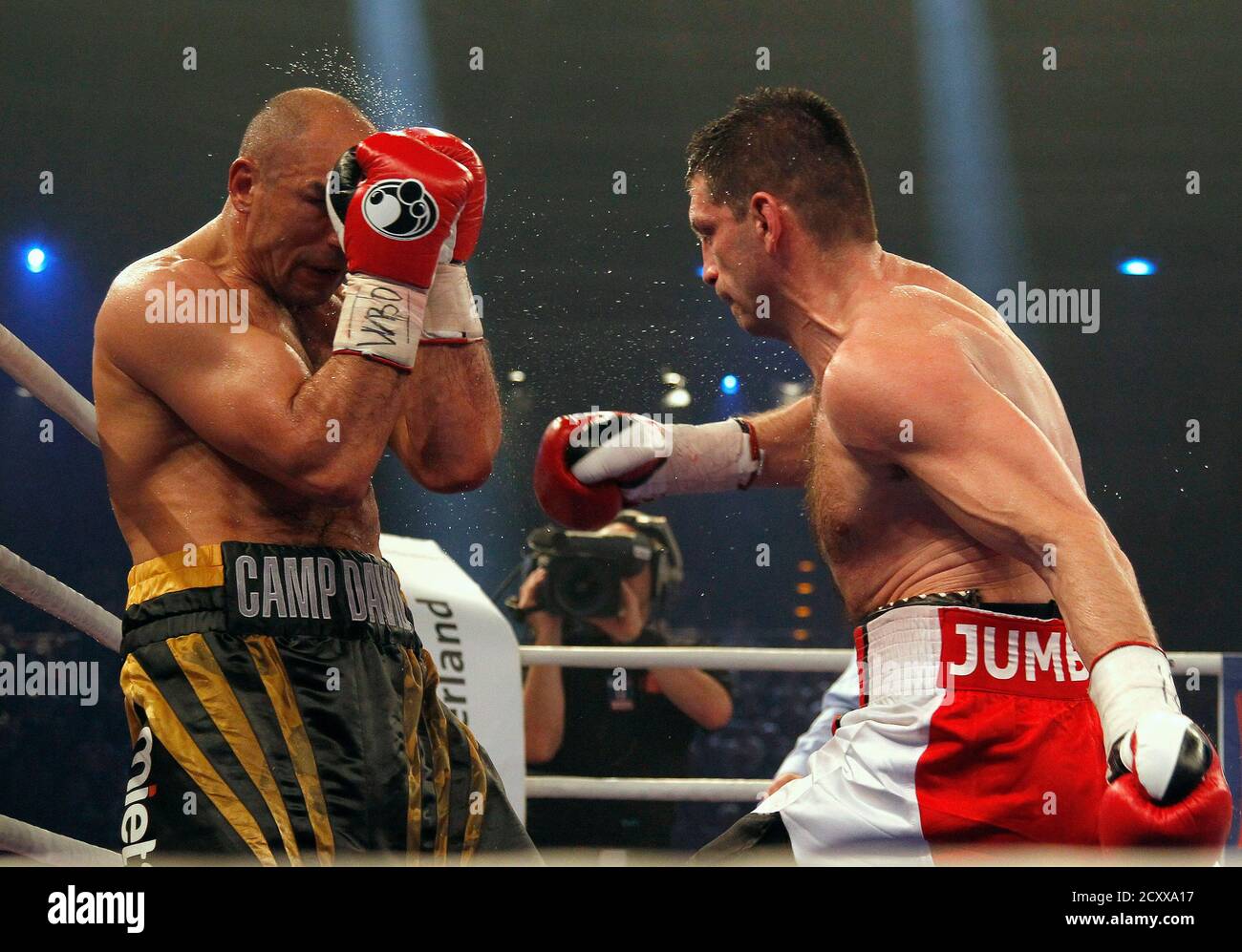 WBO Super Middleweight World Champion Arthur Abraham (L) of Germany holds  his guard up as Montenegro's Nikola Sjekloca throws a punch during their  fight in Berlin May 3, 2014. Abraham successfully defended