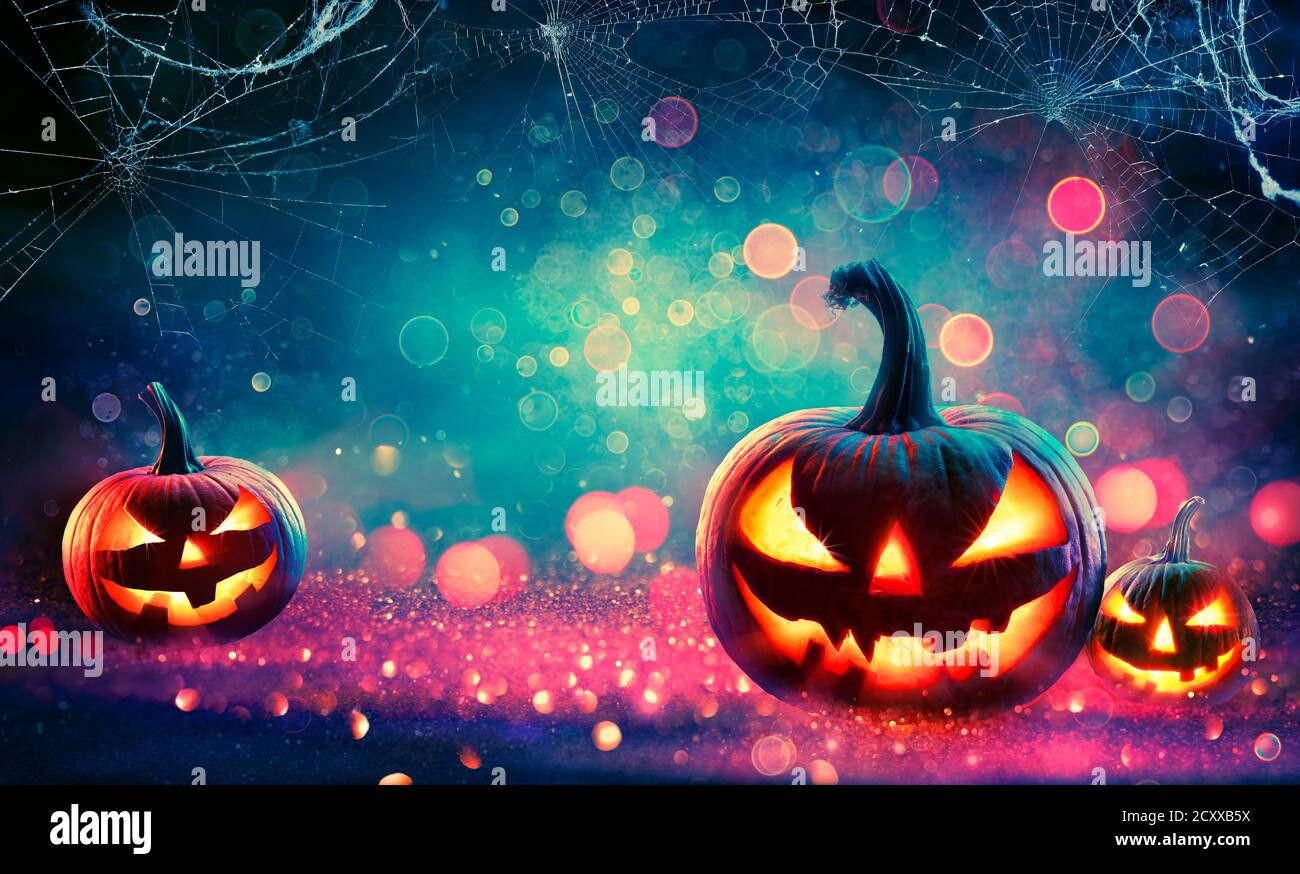 Halloween Abstract Party - Smiling Pumpkins On Defocused Shiny Background Stock Photo